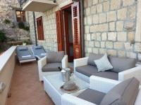 a patio with couches and a table and chairs at Villa Ana Apartments in Mlini