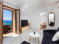 a white living room with a view of the ocean at Villa Ana Apartments in Mlini