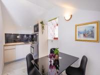 a kitchen with a dining room table and chairs at Villa Ana Apartments in Mlini