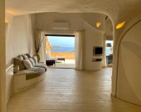 a living room with a couch and a view of the ocean at SAN TEODORO PUNTA EST FANTASTICO TRILOCALE VISTA MARE in Capo Coda Cavallo