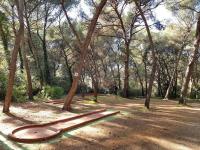 a park with a bench in the middle of trees at Appartement Six-Fours-les-Plages, 2 pièces, 5 personnes - FR-1-316-118 in Six-Fours-les-Plages
