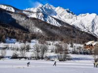 two people skiing in the snow in front of a mountain at Appartement Serre Chevalier, 1 pièce, 4 personnes - FR-1-330F-119 in Serre Chevalier