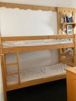 a couple of bunk beds in a room at Appartement Alpe Huez 8 personnes centre station in LʼHuez