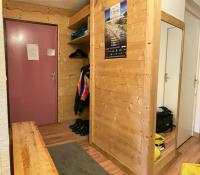 a room with a wooden wall and a door at Appartement Alpe Huez 8 personnes centre station in LʼHuez