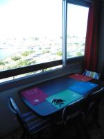 a table with a spider on it in front of a window at Vue Mer 180° Parking+Lave-Linge+Proche Plages+Piscine in Cap d&#39;Agde