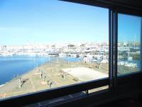 a window with a view of a marina with boats at Vue Mer 180° Parking+Lave-Linge+Proche Plages+Piscine in Cap d&#39;Agde