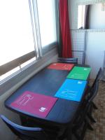a table with four colorful signs on it next to a window at Vue Mer 180° Parking+Lave-Linge+Proche Plages+Piscine in Cap d&#39;Agde