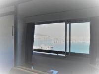 a room with a window with a view of the water at Vue Mer 180° Parking+Lave-Linge+Proche Plages+Piscine in Cap d&#39;Agde
