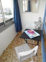 a table and a chair and a table and a mirror at Vue Mer 180° Parking+Lave-Linge+Proche Plages+Piscine in Cap d&#39;Agde