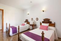 two beds in a room with white and purple sheets at Chalet Son Gomila in the North of Mallorca in Cielo de Bonaire 