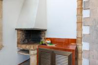 a kitchen with a brick oven in a room at Chalet Son Gomila in the North of Mallorca in Cielo de Bonaire 