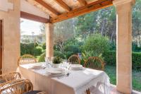 a table with a white table cloth on a patio at Chalet Son Gomila in the North of Mallorca in Cielo de Bonaire 