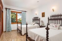 a bedroom with two beds and a window at Chalet Son Gomila in the North of Mallorca in Cielo de Bonaire 