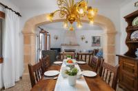 a dining room with a table and a chandelier at Chalet Son Gomila in the North of Mallorca in Cielo de Bonaire 