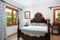 a bedroom with a bed and a window at Chalet Son Gomila in the North of Mallorca in Cielo de Bonaire 