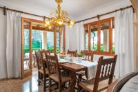 a dining room with a table and chairs and a chandelier at Chalet Son Gomila in the North of Mallorca in Cielo de Bonaire 