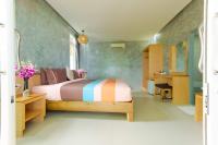 a bedroom with a large bed and a bathroom at Haadson Resort & Koh Raham in Haad Son