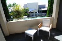 a balcony with two chairs and a swimming pool at Logis Hôtel La Fauceille in Perpignan