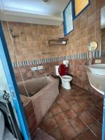 a bathroom with a tub and a toilet and a sink at Ming Jun Homestay in Eluan