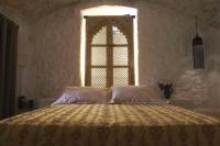 A bed or beds in a room at Dimore Santagaeta