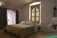A bed or beds in a room at Dimore Santagaeta