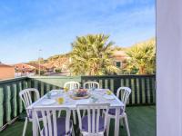 a white table and chairs on a balcony at Apartment Eden Roc 2 by Interhome in Narbonne-Plage