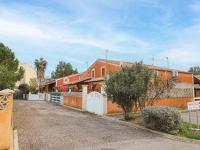 a row of houses with a white fence at Apartment Eden Roc 2 by Interhome in Narbonne-Plage