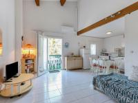 a living room with a bed a table and a kitchen at Apartment Eden Roc 2 by Interhome in Narbonne-Plage