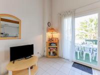 a living room with a flat screen tv and a window at Apartment Eden Roc 2 by Interhome in Narbonne-Plage