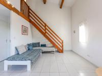 a living room with a couch and a staircase at Apartment Eden Roc 2 by Interhome in Narbonne-Plage