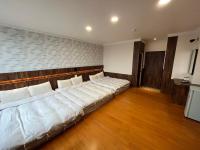 a room with a large bed with white pillows at Dongshan River Resort Farm in Wujie