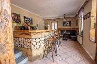 a woman sitting at a bar in a restaurant at Landhaus Müden in Faßberg