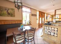 a kitchen with a wooden table and chairs in a kitchen at Landhaus Müden in Faßberg