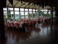 a dining room with tables and chairs and windows at Monterey Beach Hotel in Lytham St Annes