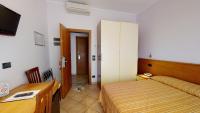 A bed or beds in a room at Miriam Hotel & Residence