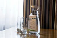 a bottle and a glass on a table at Holiday Inn Vienna City by IHG in Vienna