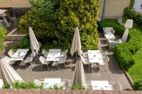 an outdoor patio with tables and umbrellas at Holiday Inn Vienna City by IHG in Vienna