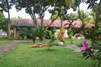 a house with a garden in front of it at Pousada São Francisco in Cumuruxatiba