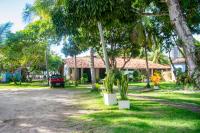 a house with a car parked in front of it at Pousada São Francisco in Cumuruxatiba