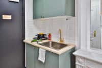 a kitchen with a sink and a microwave at Apartments WS Tour Eiffel - Laos in Paris