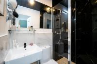 a bathroom with a sink and a shower at Apartments WS Tour Eiffel - Laos in Paris