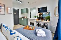 a living room with a bed and a kitchen at Apartments WS Tour Eiffel - Laos in Paris