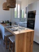 a kitchen with a island with a counter top at Belle vue sur mer, très près du port de Sanary in Sanary-sur-Mer