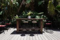 Una mesa de madera con sillas y plantas en una terraza. en Fierro Hotel Buenos Aires, en Buenos Aires