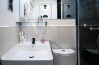 a bathroom with a sink and a toilet and a shower at Apartments WS Tour Eiffel - Laos in Paris