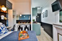 a room with a bed and a table with a tray of food at Apartments WS Tour Eiffel - Laos in Paris