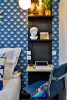a bedroom with a desk with a laptop on a blue wall at Apartments WS Tour Eiffel - Laos in Paris