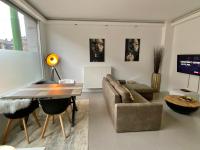 a living room with a couch and a table at Antwerp West Side in Zwijndrecht