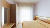 A bed or beds in a room at Miriam Hotel & Residence