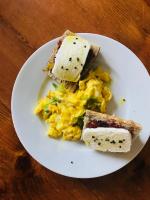 a white plate with eggs and toast on a table at Amama Baita in Urrugne